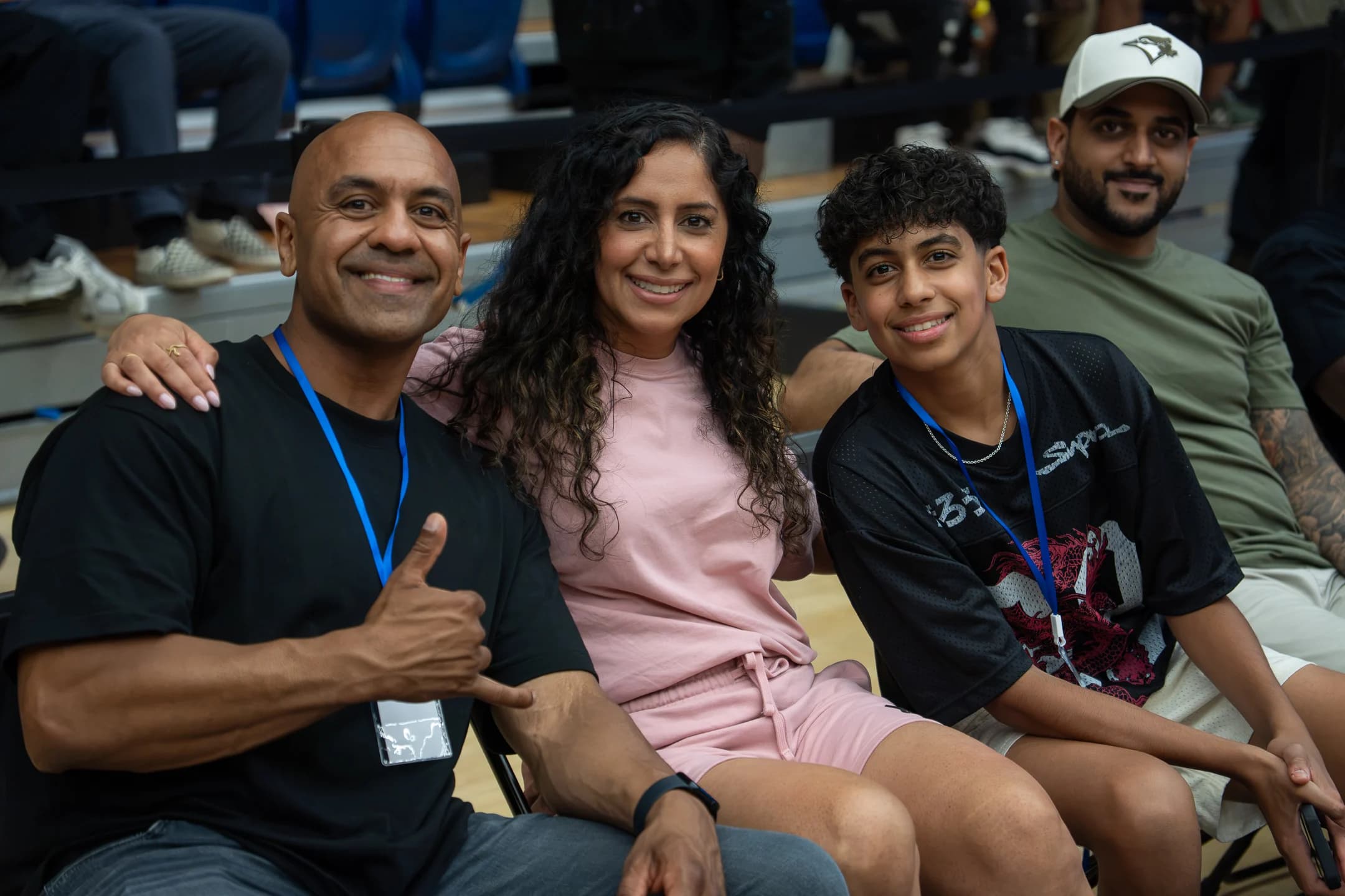 A family smiles together from their courtside seats at Mania Weekend 2026.